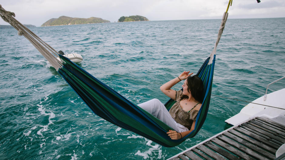 Relaxing in a hammock on your private yacht charter