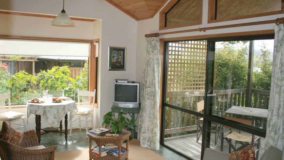 Nikau lounge with door onto deck.