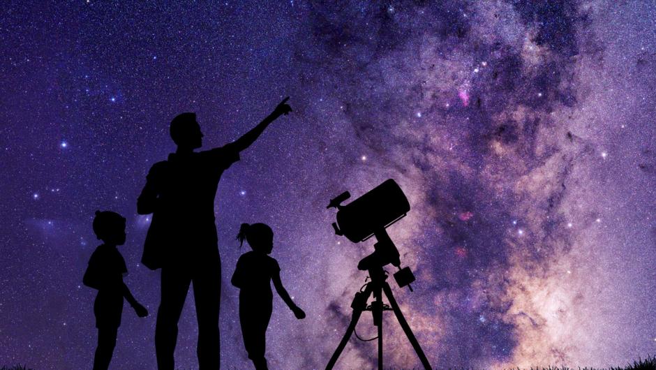 Family with a telescope admiring the Milky Way.