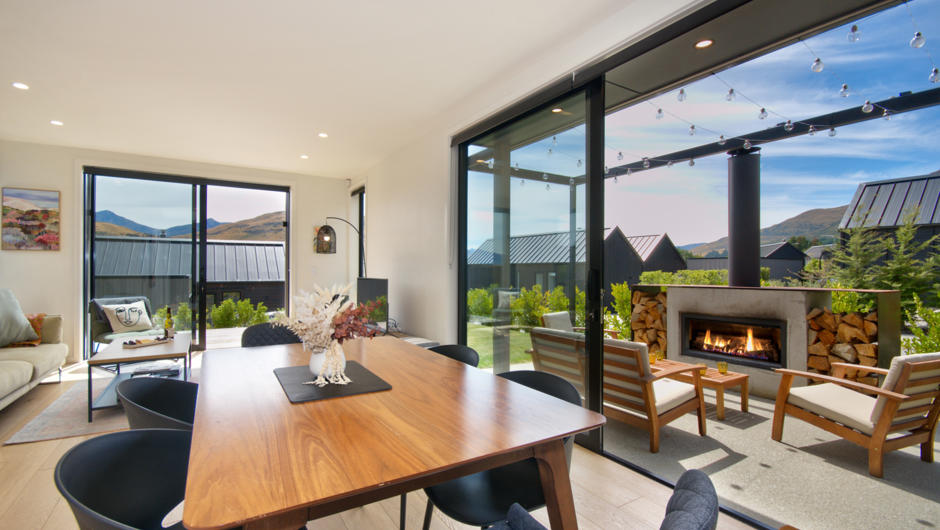 Dining area opens out to outdoor fire and patio