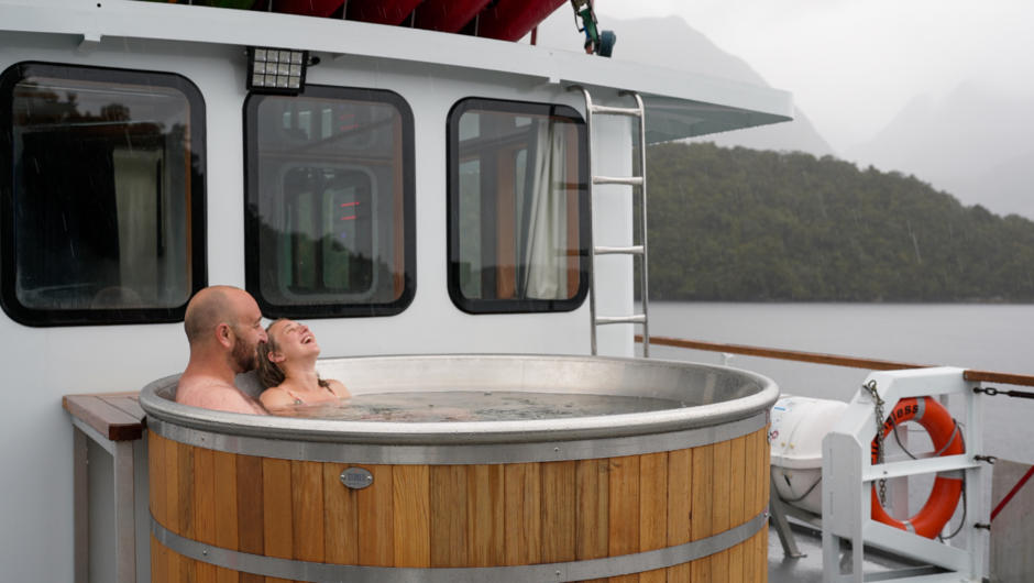 Relaxing in the hot tub after a day of adventures. MV Flightless offers five bathrooms, second saloon in the wheelhouse, full walk around deck, heli-pad, easy access to the water and a huge heatable back deck which is also partially under cover.