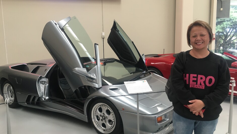 A Kaewa Tours customer admiring a Lamborghini on display at Southwards Car Museum.