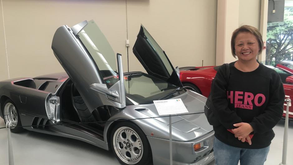 A Kaewa Tours guest at Southwards Car Museum admiring the Lamborghini Diablo VT Roadster.