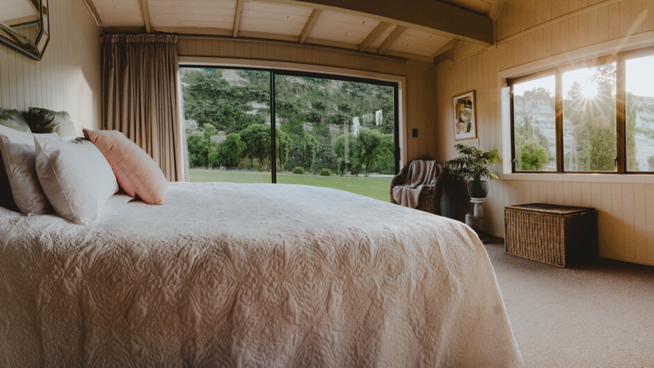 One of three bedrooms with picturesque views of the countryside, and majestic Rangitikei River. Sink into one of our many comfortable beds when you stay at Rathmoy.