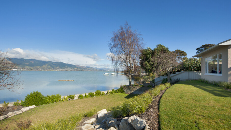 Landscaped terraced lawns lead you down to the waters edge.