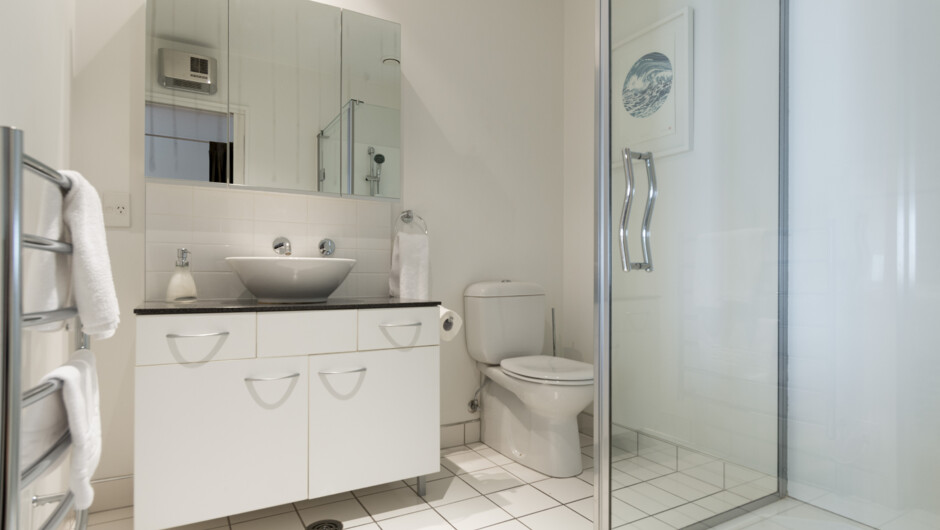 Ensuite Bathroom - tiled floors, mains pressure shower, toilet & vanity.