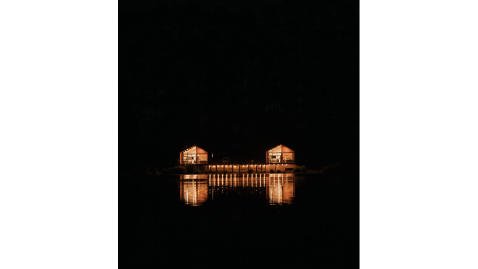 Our Chalets from across the lake at night time.