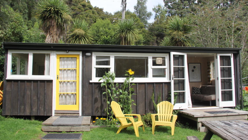 We have 4 retro rustic cabins available for hire. Kowhai, pictured, sleeps up to 8 people in 3 small bedrooms.