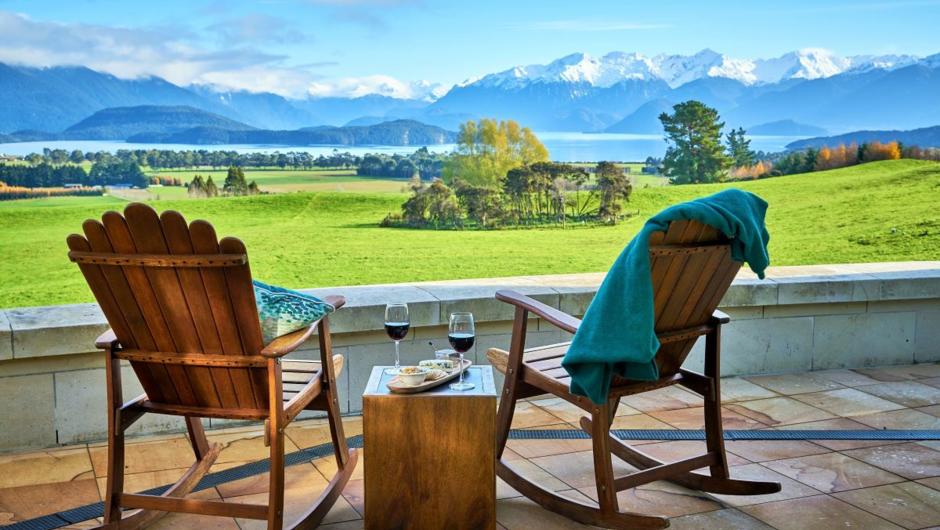 View from the outdoor patio at Cabot Lodge overlooking the farm, Lake Manapouri and Cathedral Peak Mountains.