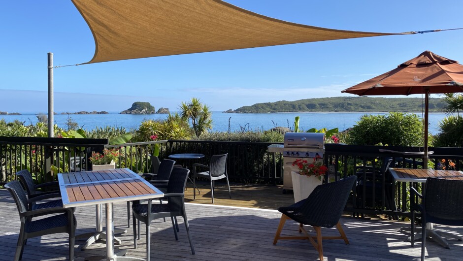The main deck of The Bay House - breakfast is served here on the warmer mornings and a gas BBQ is set up for guests to use in the summer evenings.