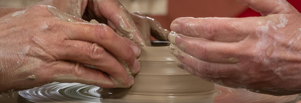 Close up of hands making a mug.