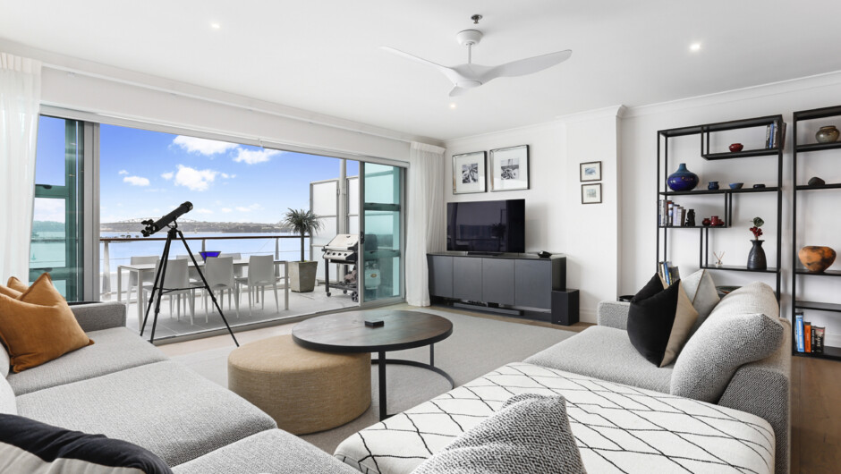 Spacious living area flows out to the balcony overlooking the water