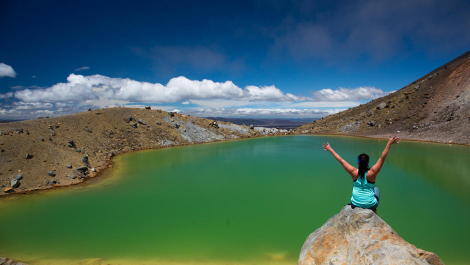 Sitting by the Emerald lake on the Tongariro Alpine Crossing