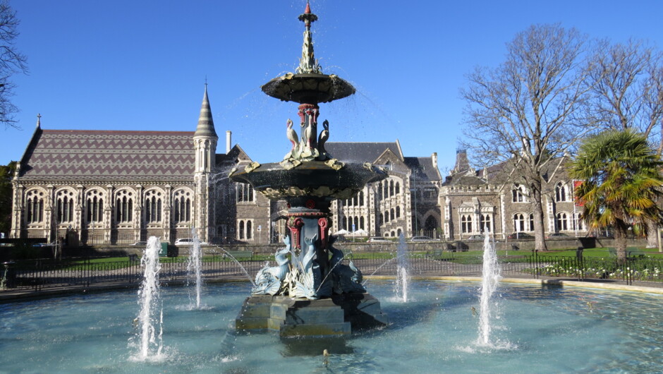 The ornate Stewart fountain in the foreground, standing boldly in the Botanic gardens with a glimpse of the partly restored Arts Centre in the background.
