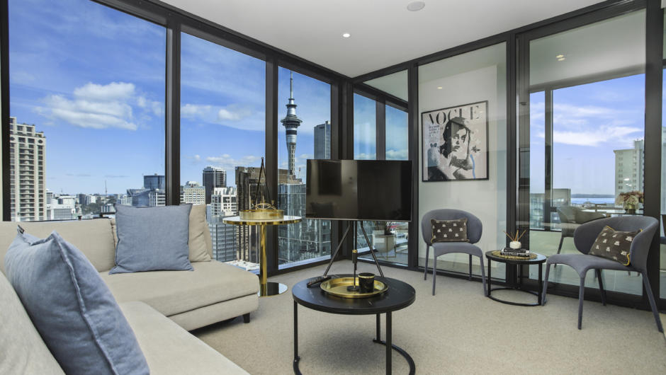Stylish living room with views of Auckland's Sky Tower.