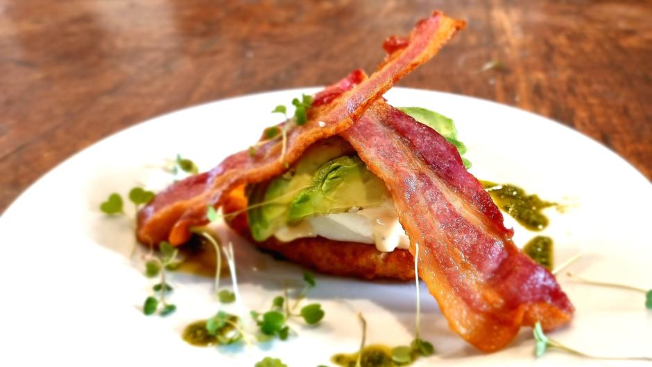 Choose a complimentary cooked breakfast, shown here, Poached egg with Bacon and Avocado on a Hollandaise covered Hash.