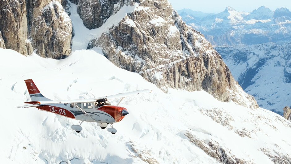 Cessna 206 flying through the mountains en route to Mt. Cook