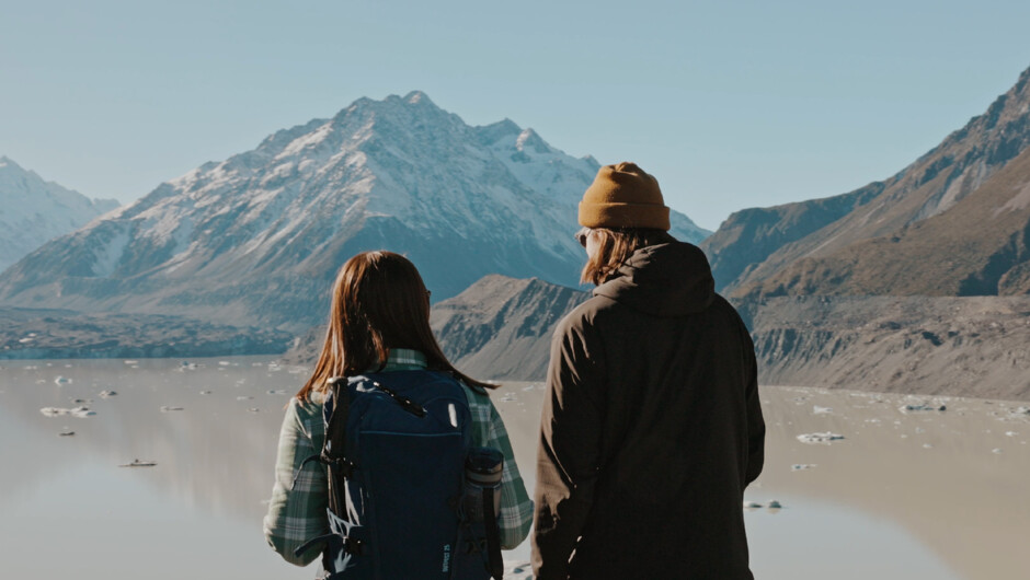 Glenorchy Air passengers looking out onto the Hooker Valley lake after hiking in Mt. Cook