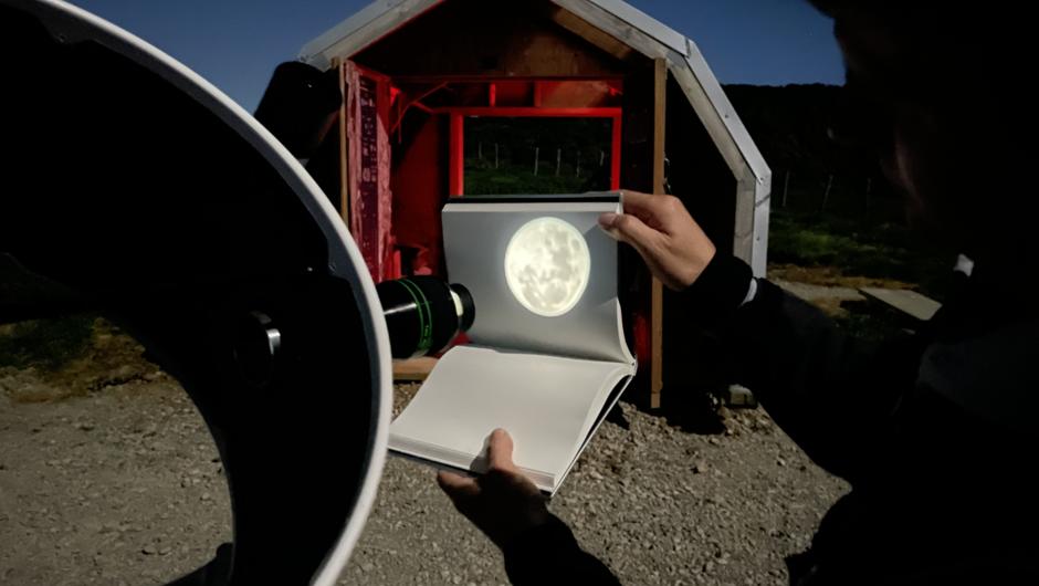 This is a projection of the Full Moon through the telescope on to one our notebooks. We can also attach your mobile phone