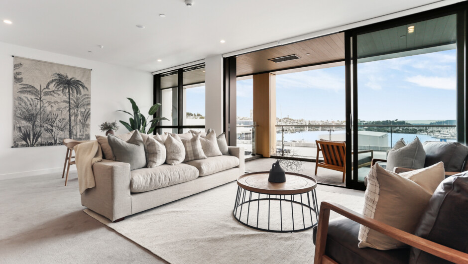 Bright and spacious living room area flows out to the covered balcony.