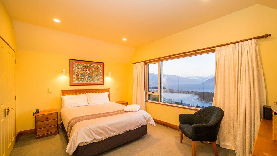 Master bedroom with views of Lake Wakatipu and an ensuite