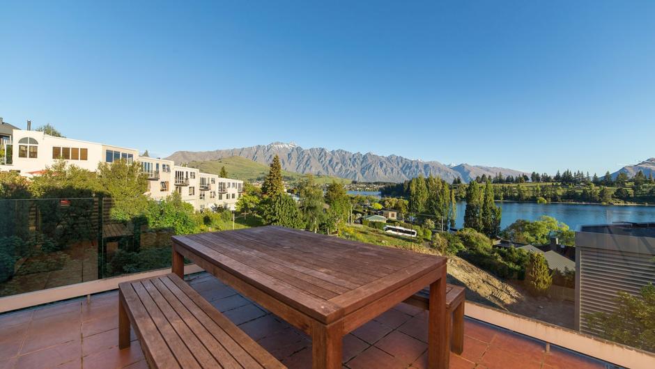 Outdoor dining on the private balcony overlooking Lake Wakatipu