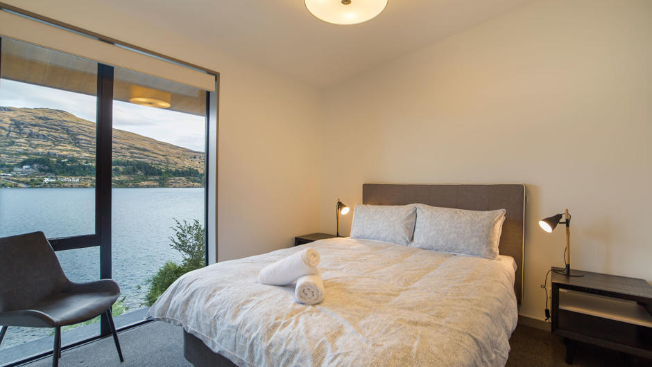 Bedroom with a queen bed and lake views