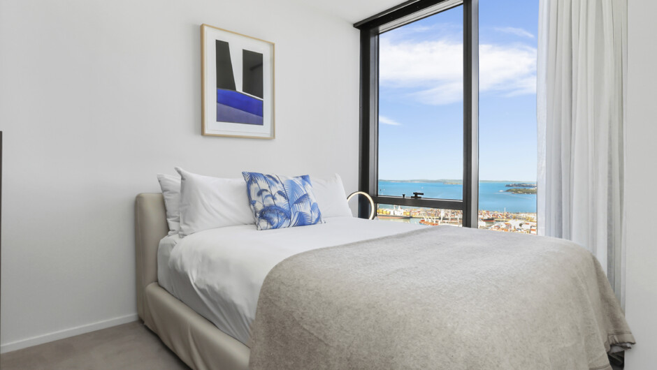 Second bedroom with floor to ceiling windows and stunning harbour and city views.