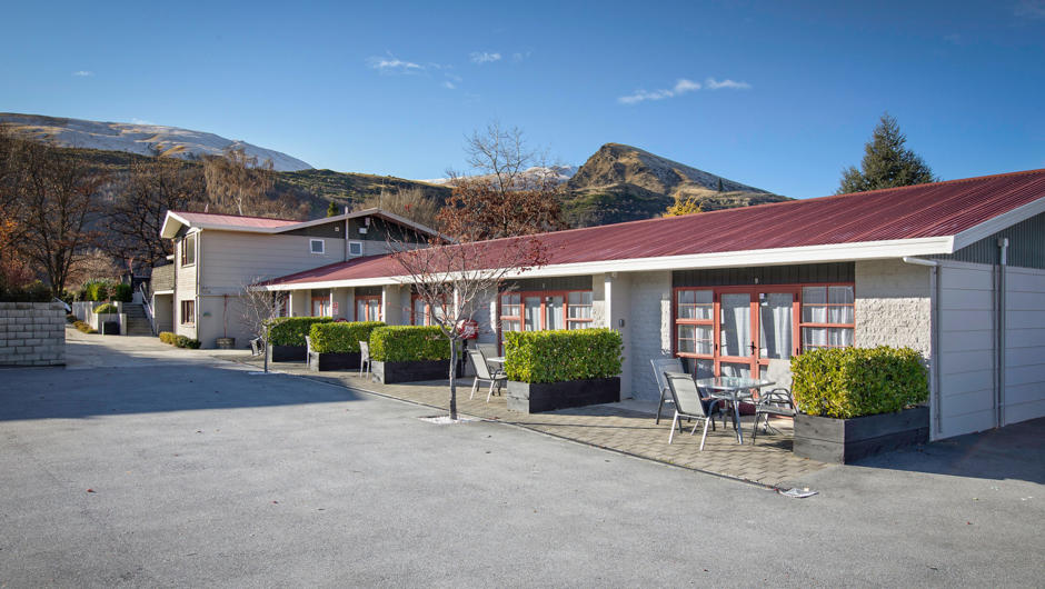 The sun is shining on Arrowtown Motel and Apartments, note generous parking space.