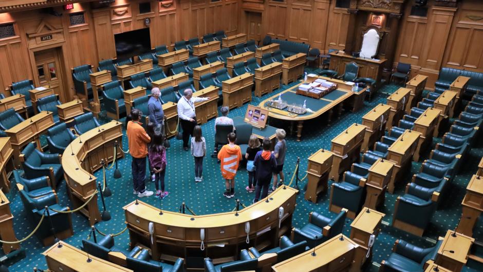 Visitors on a tour in the debating chamber at New Zealand Parliament
