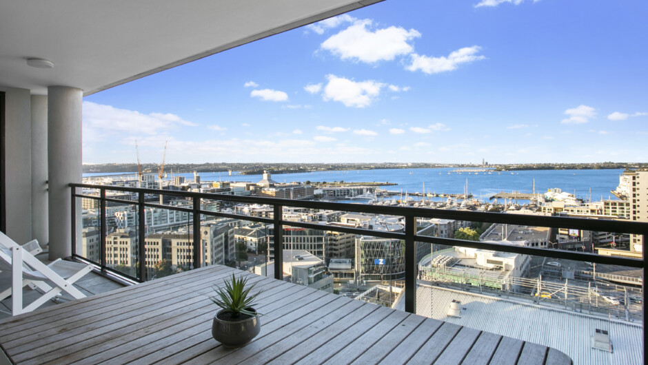 Expansive views of Auckland City and the harbour from the covered balcony