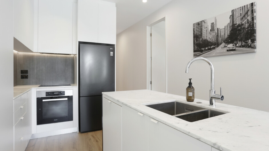 Spacious kitchen comes fully equipped with modern appliances and cooking essentials