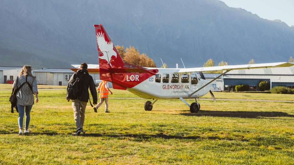 Glenorchy Air&#039;s Stewart Island Fly | Explore | Fly ex Queenstown passengers heading out to the aircraft at Queenstown Airport.