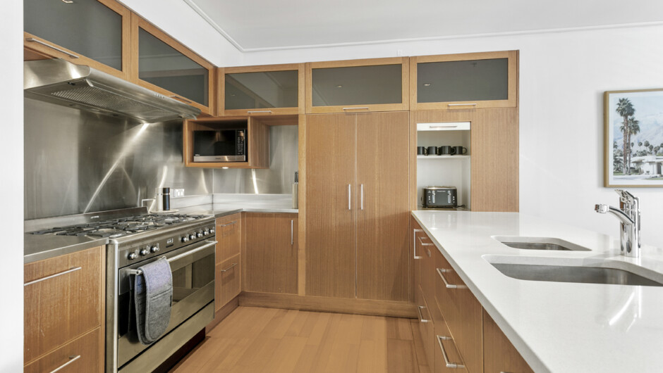 Spacious kitchen comes equipped with cooking basics and modern appliances