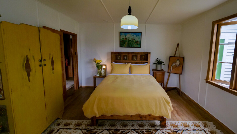 The main bedroom which overlooks a cottage garden.