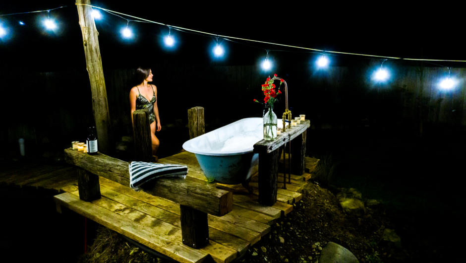The outdoor tub under a string of festoon lights - or simply relax under the stars.