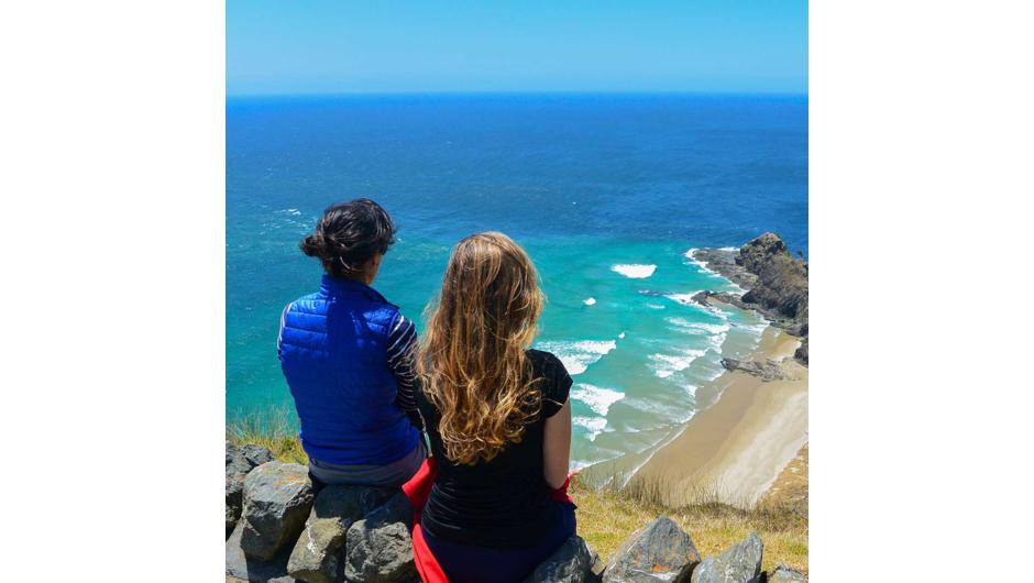 Tourists looking over Cape Reinga