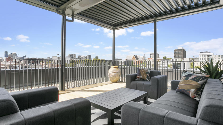Stylish seating area on the oversized balcony with stunning views over the city