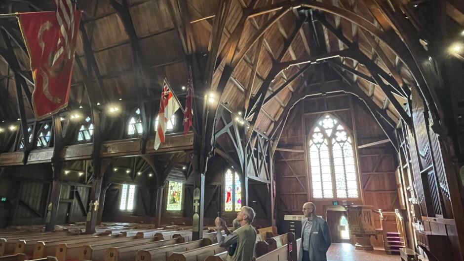 Guests experiencing a guided tour of Old St Pauls. Here the American Marine Corp and American flag (48 stars) have hung inside the Church since World War 2.