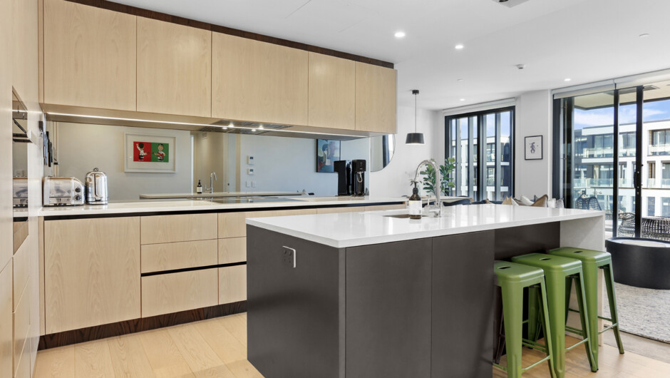 Spacious kitchen area comes equipped with modern appliances and cooking essentials