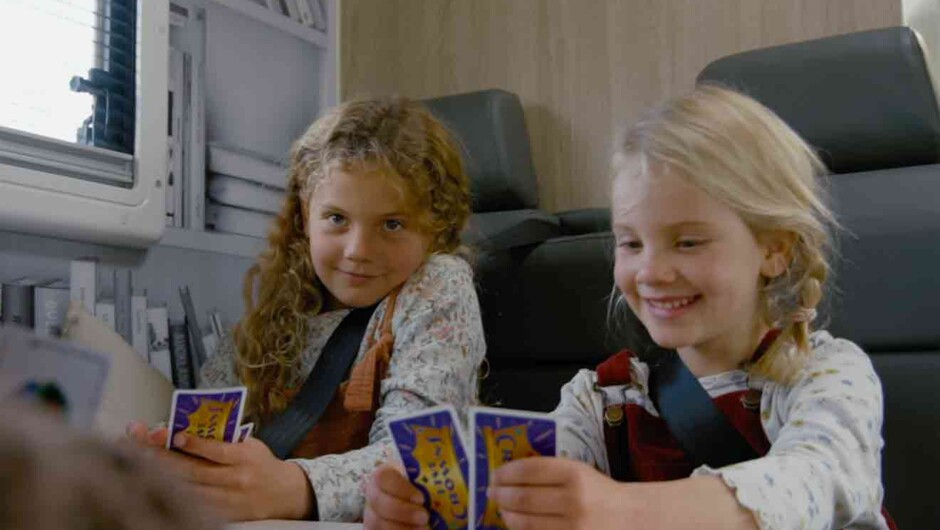 Girls playing cards in motorhome