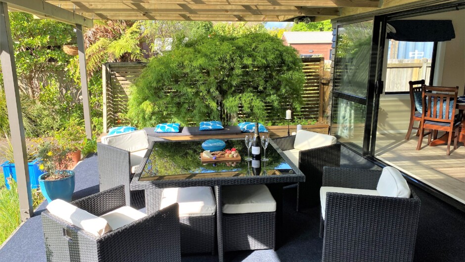 Covered outdoor dining and relaxing area. Views to Lake Rotorua and Mokoia Island.