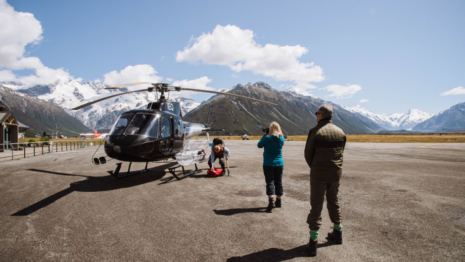 Passengers walking up the helicopter ready to fly up to the Tasman Glacier.