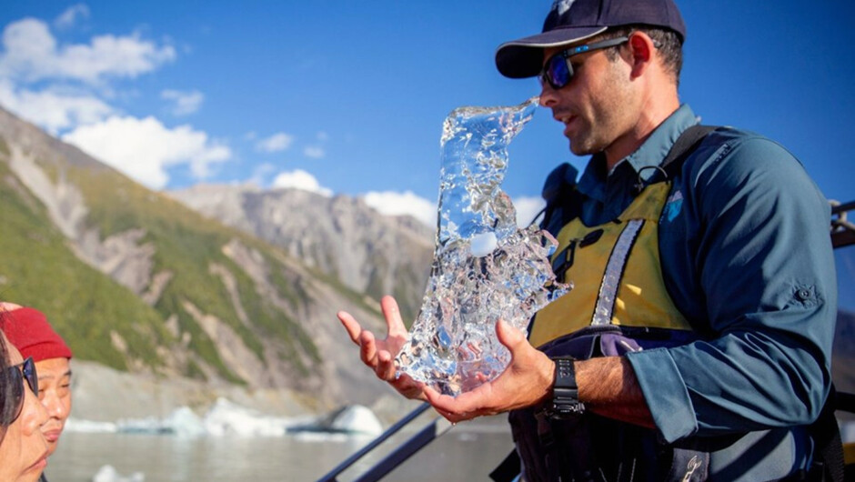 Glacier Explorers guide holding ice from the Tasman terminal lake.