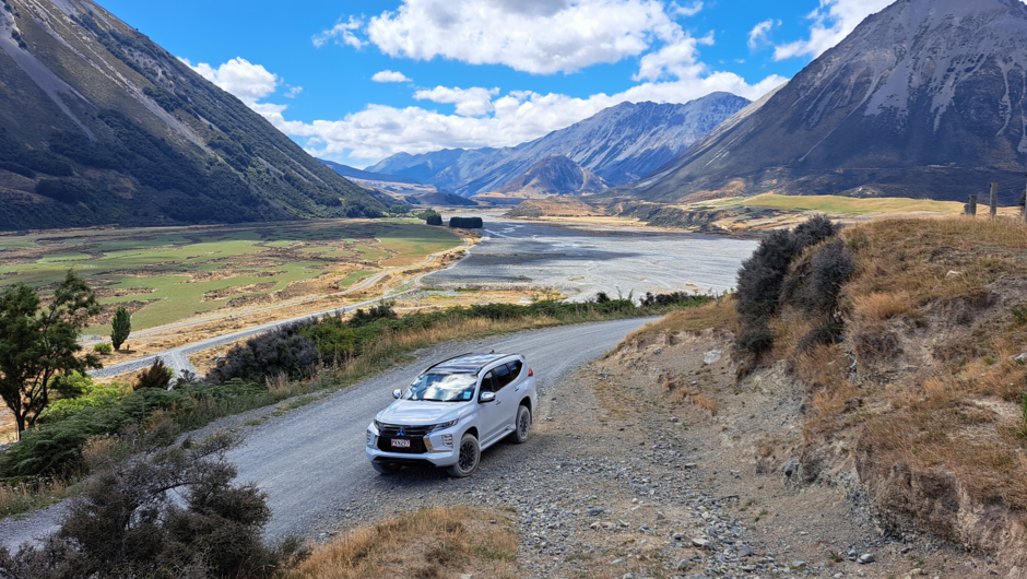 A parked GO Rentals vehicle with mountain surroundings.