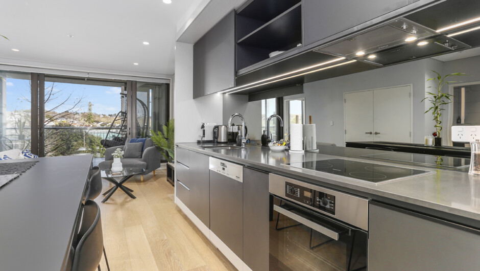 Kitchen comes equipped with modern appliances and cooking essentials
