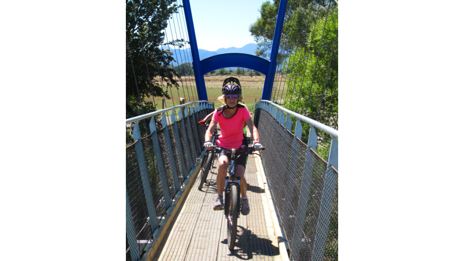 Crossing the swingbridge on the coastal section of the Great Taste Trail between Nelson and  Mapua