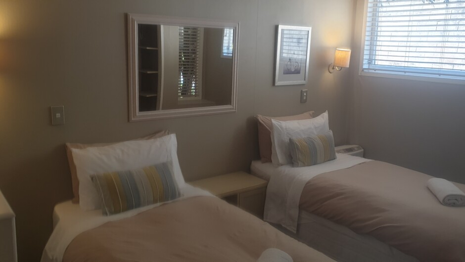 The Kimberly Room has two single beds under a skylight, heated by a thermal radiator, and shares the main bathroom (with fresh water bath) and separate toilet.