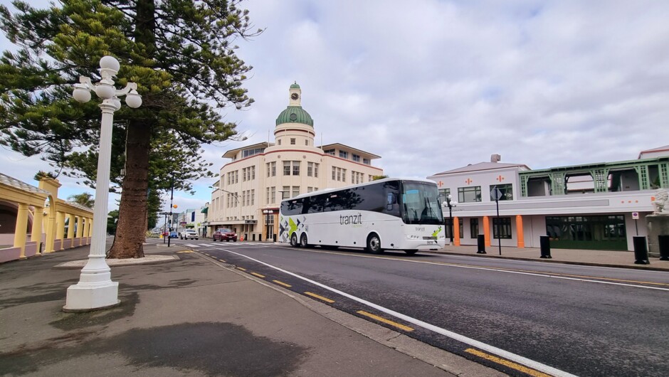 One of Tranzit Coachline's coaches passes the distinctive art deco buildings along Marine Parade in Napier.