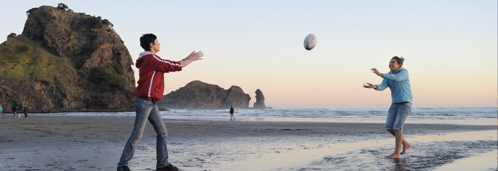 A wild New Zealand beach is a great place to toss a rugby ball around.